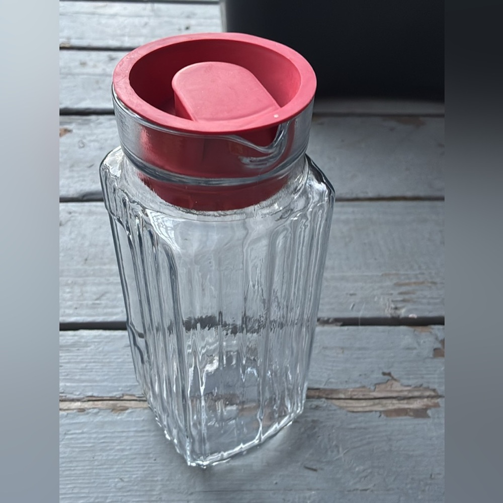 Vintage Anchor Hocking ribbed glass refrigerator pitcher with a red rubber lid.